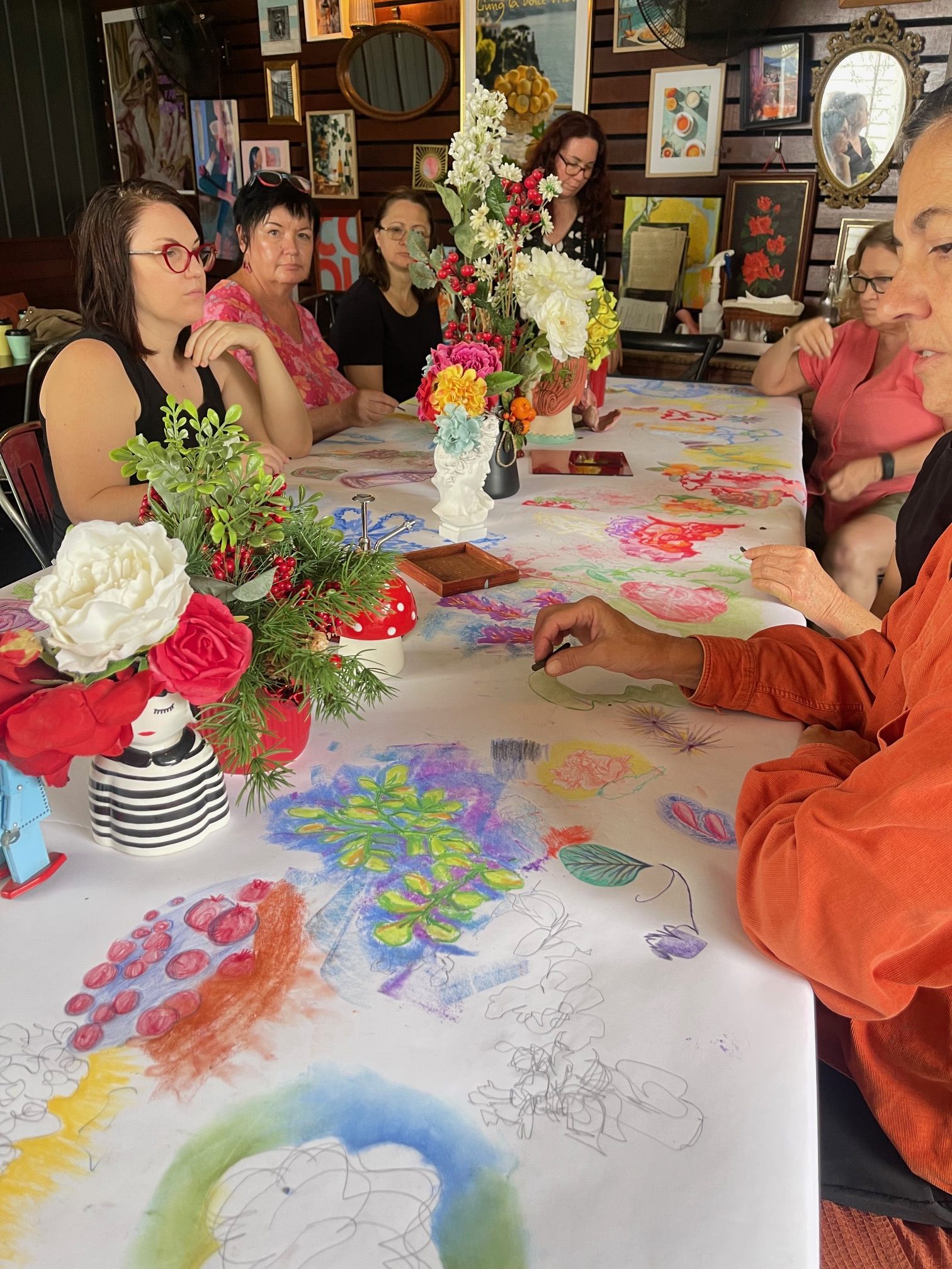 Workshop participants drawing together around a long table at Osteria Epoca