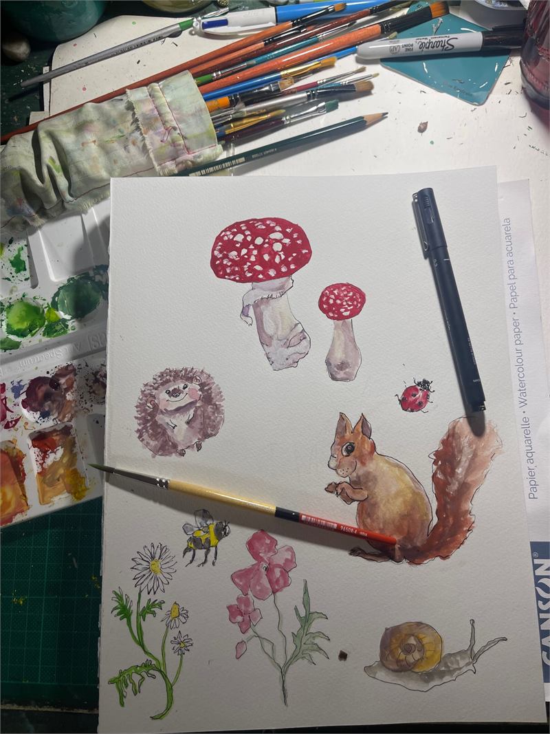 Woodlands illustration demo sheet with woodland creatures, flowers, and mushrooms